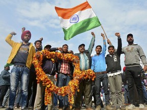Indians shout slogans carrying a huge garland as they wait to welcome Indian pilot at India Pakistan border at Wagah, 28 kilometers (17.5 miles) from Amritsar, India, Friday, March 1, 2019. Pakistan is preparing to hand over a captured Indian pilot as shelling continued for a third night across the disputed Kashmir border even as the two nuclear-armed neighbors seek to defuse the most serious confrontation in two decades.