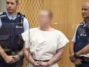 Brenton Tarrant (his identity obscured due to court order) is lead into the dock for his appearance for murder in court on March 16, 2019 in Christchurch, New Zealand.
