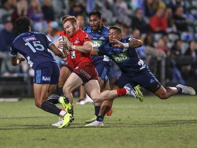 Sunwolves Jamie Booth, center, breaks away from the pack during the Super Rugby match between the Blues and the Sunwolves in Auckland, New Zealand, Saturday, March 9, 2019.