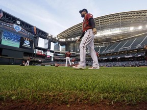 Arizona Diamondbacks' Steven Souza Jr. walks on new turf at the team's home field before a spring training baseball game against the Chicago White Sox, Monday, March 25, 2019, in Phoenix, Ariz. The synthetic grass at Chase Field is designed specifically for baseball. The team previously played on grass there.