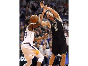 Milwaukee Bucks center Brook Lopez, right, is fouled by Phoenix Suns forward Josh Jackson, left, during the first half of an NBA basketball game, Monday, March 4, 2019, in Phoenix.