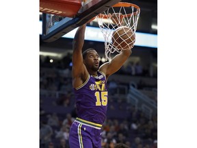 Utah Jazz forward Derrick Favors dunks against the Phoenix Suns during the first half of an NBA basketball game Wednesday, March 13, 2019, in Phoenix.