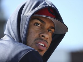 An injured Cleveland Indians shortstop Francisco Lindor watches teammates from the dugout during the second inning of a spring training baseball game against the San Diego Padres, Monday, March 18, 2019, in Goodyear, Ariz.