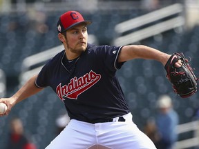 FILE - In this Feb. 25, 2019 file photo, Cleveland Indians starting pitcher Trevor Bauer throws against the Texas Rangers during the first inning of a spring training baseball game in Goodyear, Ariz.  Presumably, they will all be ready to pitch the first week of the season, establishing the order of Cleveland's starting rotation is on hold for Indians manager Terry Francona with 19 days remaining before the season opener, March 28 at Minnesota.