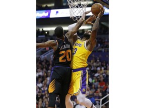 Los Angeles Lakers forward LeBron James (23) drives past Phoenix Suns forward Josh Jackson during the first half of an NBA basketball game Saturday, March 2, 2019, in Phoenix.