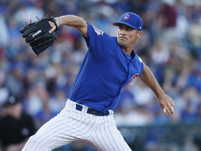 Chicago Cubs pitcher Cole Hamels throws during the first inning of a spring training baseball game against the Boston Red Sox on Monday, March 25, 2019, in Mesa, Ariz.