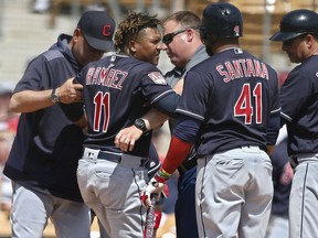 Cleveland Indians' Jose Ramirez (11) is helped to his feet after an injury during the third inning of the team's spring training baseball game against the Chicago White Sox on Sunday, March 24, 2019, in Glendale, Ariz. From left are manager Terry Francona, Ramirez, athletic trainer Jeff Desjardins, Carlos Santana (41) and third base coach Mike Sarbaugh (16).