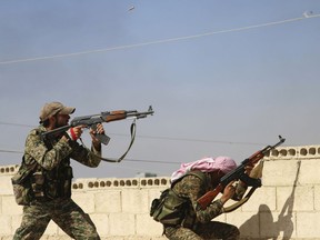 In this Oct. 11, 2015 file photo, Syrian soldiers fire repelling an attack in Achan, Hama province, Syria. Waves of violence in northwestern Syria has killed scores of people since mid January 2019 and displaced tens of thousands raising concerns that a truce reached in Sept. 2018 between Turkey and Russia is in danger as the final battle to retake the Islamic State group's last pocket of territory plays out in eastern Syria.