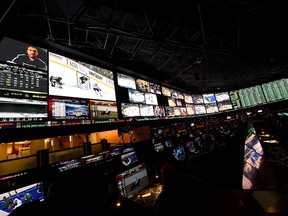 The betting line and some of the nearly 400 proposition bets for Super Bowl 50 between the Carolina Panthers and the Denver Broncos are displayed at the Race & Sports SuperBook at the Westgate Las Vegas Resort & Casino in a file photo from Feb. 2, 2016.