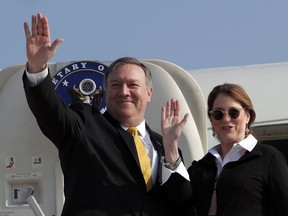 U.S. Secretary of State Mike Pompeo and his wife Susan wave before boarding their airplane to Beirut at Ben Gurion airport near Lod, Israel, Friday, March 22, 2019.