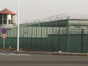 FILE - In this Monday, Dec. 3, 2018, file photo, a guard tower and barbed wire fences surround an internment facility in the Kunshan Industrial Park in Artux in western China's Xinjiang region. A U.S. envoy on religion has described China's internment of an estimated 1 million Muslims as a "horrific situation." Ambassador-at-large Sam Brownback called for an independent investigation into the detentions and the release of those being held.