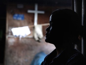 FILE - In this March 21, 2018, file photo, Marip Lu sits in her family's shelter in a refugee camp in northern Kachin State, Myanmar. Marip Lu, 24, claims she was kidnapped by traffickers and suffered six years of captivity, rape and abuse deep in China. A human rights group says the governments in Myanmar and China are failing to stop the brutal trafficking of young women from the conflict-ridden Kachin region for sexual slavery.