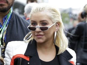 FILE - In this April 29, 2018, file photo, American singer Christina Aguilera arrives at the starting grid prior to the start of the Azerbaijan Formula One Grand Prix, at the city circuit, in Baku, Azerbaijan. The nation's largest LGBTQ civil rights organization is honoring Aguilera with its Ally for Equality award. The Human Rights Campaign announced Thursday the six-time Grammy-winning singer is a true "LGBTQ icon" who uses her platform to "share a message of hope and inspiration" to those who have been marginalized.