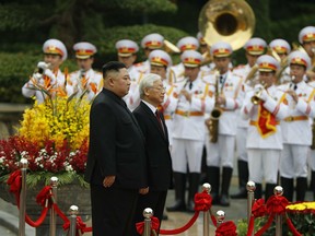 North Korea's leader Kim Jong Un, center left, and Vietnam's President Nguyen Phu Trong attend a welcoming ceremony at the Presidential Palace, Friday, March 1, 2019, in Hanoi, Vietnam.