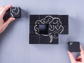 The concept of the human brain. Education, science and medical concept.  Brain drawn in chalk on black cubes.