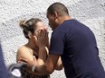 A man comforts a woman at the Raul Brasil State School in Suzano, Brazil, Wednesday, March 13, 2019.
