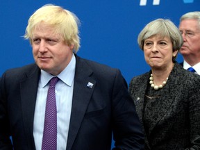 In this Thursday, May 25, 2017 file photo British Foreign Secretary Boris Johnson, left, and Britain's Prime Minister Theresa May arrive for a meeting during the NATO summit of heads of state and government, at the NATO headquarters, in Brussels.