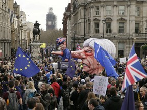 An effigy of British Prime Minister Theresa May is wheeled through Trafalgar Square during a Peoples Vote anti-Brexit march in London.