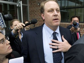 FILE - In this Wednesday, May 16, 2012, file photo, former Boston Red Sox pitcher Curt Schilling, center, is followed by members of the media as he departs the Rhode Island Economic Development Corporation headquarters, in Providence, R.I. Wells Fargo Securities has agreed to pay an $800,000 civil penalty to settle a U.S. Securities and Exchange Commission lawsuit over Rhode Island's failed $75 million deal with Schilling's 38 Studios video game company. Wells Fargo and the SEC announced the proposed settlement in filings with the U.S. District Court in Providence on Monday, March 18,2019. A federal judge must approve it.