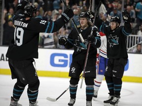 San Jose Sharks' Marcus Sorensen, center, celebrates with Joe Thornton (19) and Kevin Labanc, right, after scoring a goal against the Montreal Canadiens during the first period of an NHL hockey game Thursday, March 7, 2019, in San Jose, Calif.