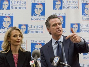 California Gov. Gavin Newsom with his wife, Jennifer Siebel Newsom attend a roundtable discussion with Central American community leaders at the Clinica Monsenor Oscar Romero in Los Angeles Thursday, March 28, 2019. Newsom said Thursday he will travel to El Salvador in April to discuss the poverty and violence that's causing waves of migrants to seek asylum in the United States.
