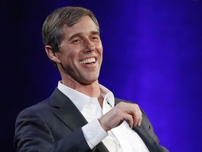 FILE - In this Tuesday, Feb. 5, 2019 file photo, former Democratic Texas congressman Beto O'Rourke laughs during a live interview with Oprah Winfrey on a Times Square stage at "SuperSoul Conversations," in New York.  The new Beto O'Rourke documentary, "Running With Beto," ends with him musing about how to keep the momentum of his 2018 defeat in the Texas Senate race going. O'Rourke himself attended the premiere Saturday, March 9, 2019, at South by Southwest, but he also was coy about his future, repeating only that he'll announce his plans "soon."