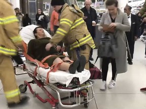 In this still image taken from video provided by WNBC-TV News 4 New York, emergency medical personnel tend to an injured passenger from a Turkish Airlines flight at New York's John F. Kennedy International Airport, Saturday, March 9, 2019. Officials say severe turbulence injured at least 30 people aboard a Turkish Airlines flight from Istanbul that landed safely at New York's Kennedy International Airport on Saturday. (WNBC-TV News 4 New York via AP)