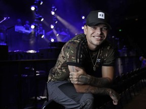 FILE - In this Sept. 22, 2018, file photo, country singer Kane Brown poses in Nashville, Tenn. Brown and producer Polow Da Don are suing each other over a contract dispute that has both sides claiming they are owed money. The producer claimed Brown breached his initial contract and asked for damages in a Feb. 2019 lawsuit. Brown's attorneys filed a countersuit Monday, March 18, 2019, claiming that Brown was misled about the agreement and that the contract is fraudulent.