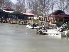This image taken from video provided by Mohammed Issam shows boats trying to rescue people in the Tigris River after a overloaded ferry sank on Thursday, March 21, 2019 near Mosul, Iraq. Col. Hussam Khalil, head of the Civil Defense in the northern Nineveh province, told The Associated Press the accident occurred as scores of people were out in a tourist area celebrating Nowruz, which marks the Kurdish new year and the arrival of spring.  (Mohammed Issam via AP)