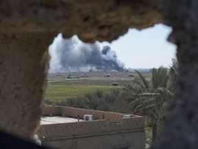 Columns of black smoke billow from the last small piece of territory held by Islamic State militants as U.S. backed fighters pounded the area with artillery fire and occasional airstrikes in Baghouz, Syria, Sunday, March 3, 2019.