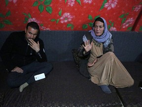 In this Thursday, Feb. 28, 2019 picture, Baseh Hammo, a Yazidi woman who escaped enslavement by Islamic State group militants, sits with a relative in a camp for displaced people outside Dahuk, Iraq. Yazidi women enslaved by IS who escaped captivity say there could be hundreds of other women still missing, women who may never return home. They say they fear many perished in bondage or war while others chose to remain in captivity to stay with the children they were forced to have.