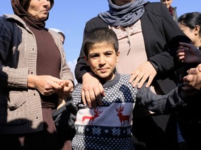 Dilbar Ali Ravu, 10, is reunited with his family in Iraq after five years of captivity with ISIL, Saturday, March 2, 2019.