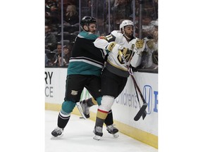 Anaheim Ducks' Korbinian Holzer, left, shoves Vegas Golden Knights' Pierre-Edouard Bellemare during the first period of an NHL hockey game Friday, March 1, 2019, in Anaheim, Calif.