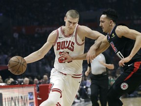Chicago Bulls' Lauri Markkanen, left, is defended by Los Angels Clippers' Landry Shamet during the first half of an NBA basketball game Friday, March 15, 2019, in Los Angeles.