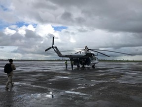 A UN humanitarian helicopter prepares for a day of work, at the airport in the Mozambique city of Beira, Friday March 22 2019.  Some hundreds of people are dead, many more still missing and with many thousands at risk from massive flooding in Mozambique, Malawi and Zimbabwe caused by Cyclone Idai.