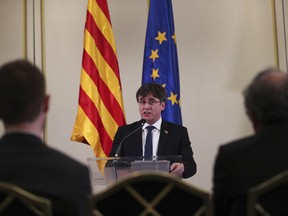 In this Feb. 18, 2019 file photo, Catalonia's former regional president. Carles Puigdemont, addresses a conference in Brussels.
