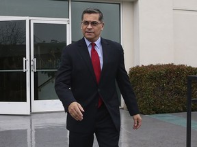 California Attorney General Xavier Becerra leaves leaves the Calvary Christian Center after meeting with SeQuette Clark, Tuesday, March 5, 2019, in Sacramento, Calif. Becerra is expected later today to announce the results of his criminal investigation into the shooting death of Clark's son, Stephon Clark, by Sacramento police officers last year.