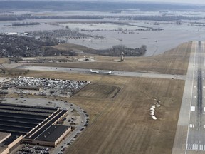 This March 17, 2019 photo released by the U.S. Air Force shows an aerial view of Offutt Air Force Base and the surrounding areas affected by flood waters in Neb. Surging unexpectedly strong and up to 7 feet high, the Missouri River floodwaters that poured on to much the Nebraska air base that houses the U.S. Strategic Command overwhelmed the frantic sandbagging by troops and their scramble to save sensitive equipment, munitions and aircraft.