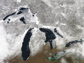 In this March 12, 2019 satellite photo provided by NOAA, shows the Great Lakes in various degrees of snow and ice. A scientific report says the Great Lakes region is warming faster than the rest of the U.S., which likely will bring more flooding and other extreme weather events such as heat waves and drought. The warming climate also could mean less overall snowfall even as lake-effect snowstorms get bigger. The report by researchers from universities primarily from the Midwest says agriculture could be hit especially hard, with later spring planting and summer dry spells. (NOAA via AP)