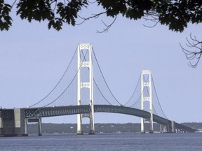 FILE - In this July 19, 2002 file photo, the Mackinac Bridge that spans the Straits of Mackinac is shown from Mackinaw City, Mich. Michigan Gov. Gretchen Whitmer has ordered state departments and agencies to take no further action on legislation enacted in late 2018 authorizing construction of an oil pipeline tunnel beneath lakes Huron and Michigan. On Thursday, March 28, 2019, Michigan Attorney General Dana Nessel, deemed unconstitutional a 2018 law that established a panel to oversee construction and operation of an oil pipeline tunnel beneath the channel linking Lakes Huron and Michigan.
