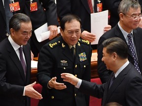 Chinese President Xi Jinping, right, shakes hands with Foreign Minister Wang Yi and Defence Minister Wei Fenghe after the closing session of the Chinese People's Political Consultative Conference at the Great Hall of the People in Beijing on March 13, 2019.