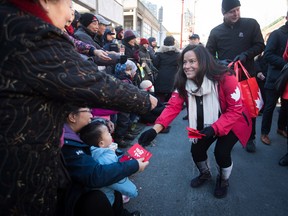 Jody Wilson-Raybould hands out lucky red envelopes during the Chinese New Year Parade in Vancouver on Sunday, Feb. 10, 2019.