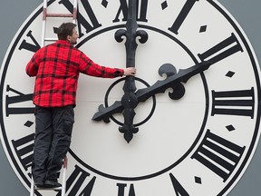 A technician adjusts the clock of the Lukaskirche Church in Dresden, eastern Germany, in a file photo from March 23, 2018.