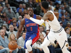 Detroit Pistons guard Reggie Jackson, left, drives past Denver Nuggets guard Will Barton, right, in the first half of an NBA basketball game Tuesday, March 26, 2019, in Denver.
