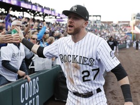 FILE - In this Sept. 30, 2018, file photo, Colorado Rockies shortstop Trevor Story is congratulated by fans after the ninth inning of a baseball game against the Washington Nationals in Denver.