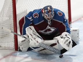 Colorado Avalanche goaltender Philipp Grubauer makes a stick-save against the Arizona Coyotes in the first period of an NHL hockey game Friday, March 29, 2019, in Denver.