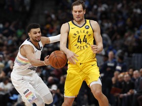 Denver Nuggets guard Jamal Murray, left, knocks the ball away from Indiana Pacers forward Bojan Bogdanovic during the first half of an NBA basketball game Saturday, March 16, 2019, in Denver.