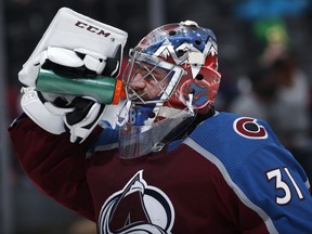 Colorado Avalanche goaltender Philipp Grubauer takes a drink during a timeout during the second period of the team's NHL hockey game against the New Jersey Devils on Sunday, March 17, 2019, in Denver.