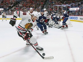 Chicago Blackhawks right wing Patrick Kane (88) controls the puck against the Colorado Avalanche during the first period of an NHL hockey game, Saturday, March 23, 2019 in Denver.