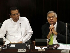 FILE- In this Oct. 3, 2017, file photo, Sri Lankan President Maithripala Sirisena, left, and Prime Minister Ranil Wickremesinghe attend a special session held to mark the country's seventieth anniversary of the first parliament of democracy, in Colombo, Sri Lanka. Sirisena has kept his country's internal political rift from spilling over to a UN human rights council meeting this week by abandoning plans to oppose his prime minister's decision to co-sponsor a resolution that would give the island nation more time to address war crime allegations stemming from its long civil war. The co-resolution to be adopted on March 21, 2019 would give Sri Lanka two more years to investigate and prosecute suspects of rights violations.